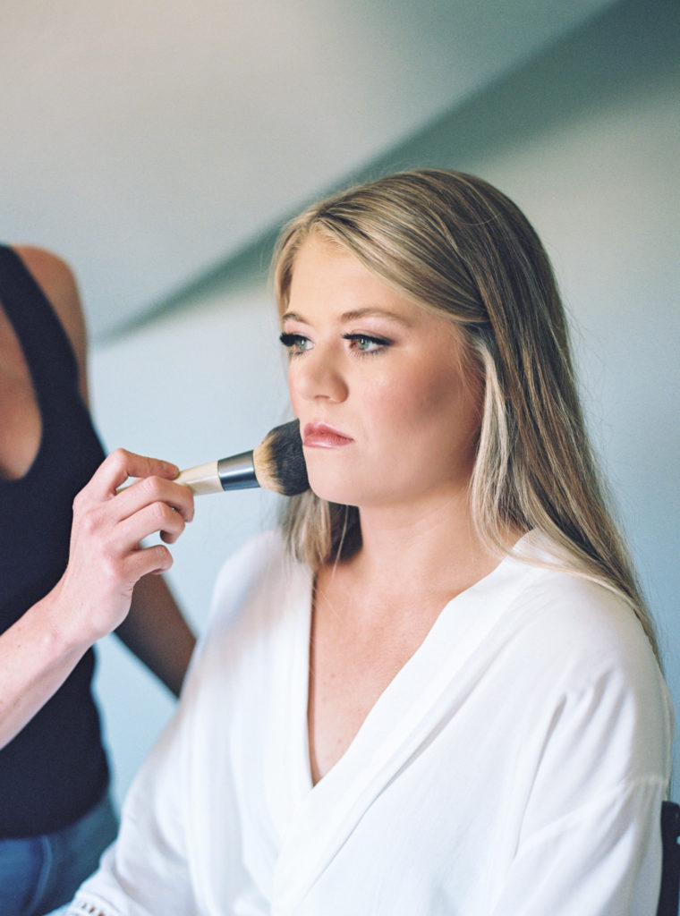 Bride having her makeup done for her wedding day