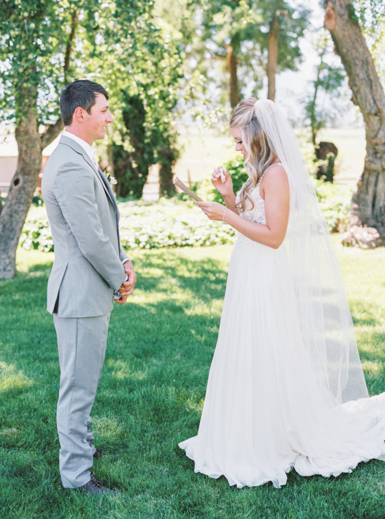 Bride and groom share their wedding vows with each other privately.