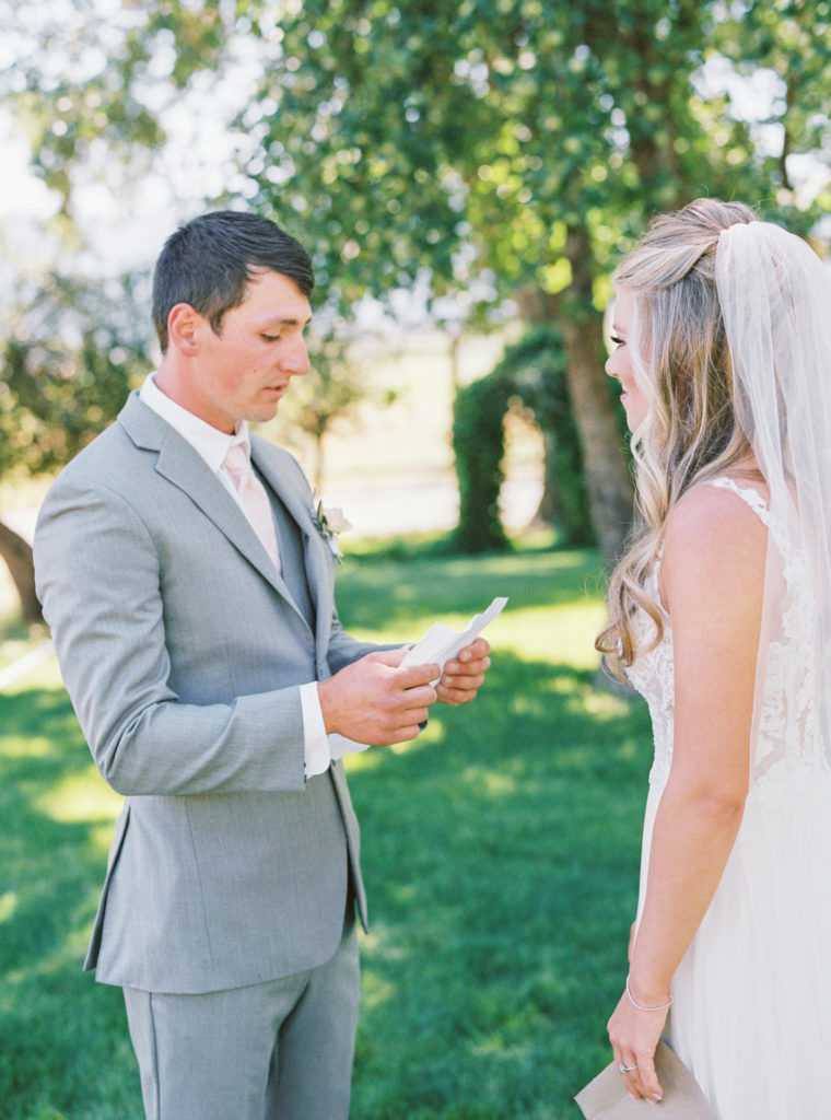 Bride and groom share their wedding vows with each other privately.